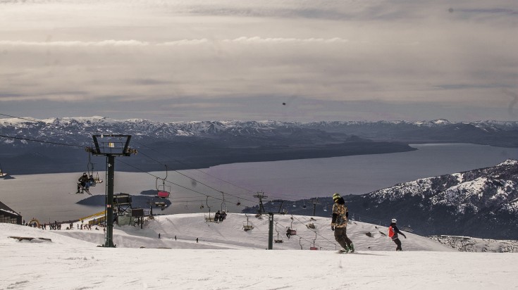 People snowboarding in Cerro Cathedral during dusk, Bariloche. People snowboarding in Cerro Cathedral during dusk, Bariloche.