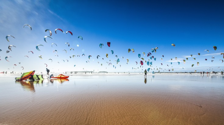 Tourists kite surfing at Essaouira Beach in Morocco.