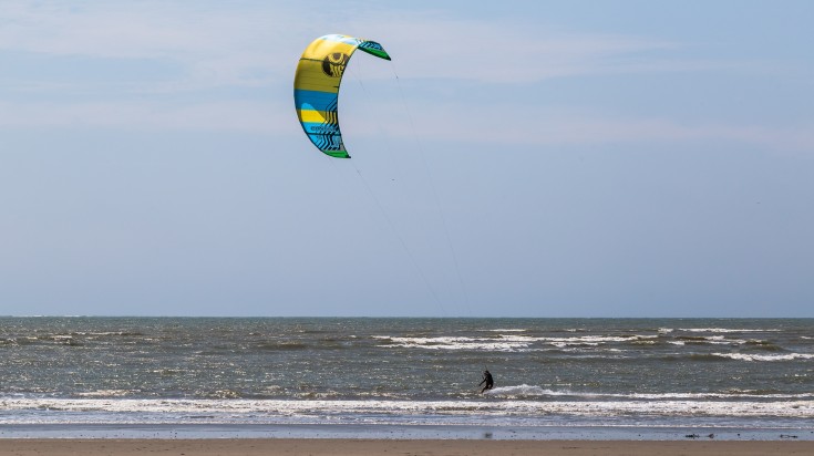 A person kitesurfing at a beach in Ecuador. A person kitesurfing at a beach in Ecuador.
