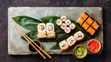 In the past, sushi was referred to fish pickled and preserved in vinegar but in the present sushi is known as a food consisting of sticky rice with raw fish and vegetables. Sushi is prepared with rice and various toppings like salmon and veggies.