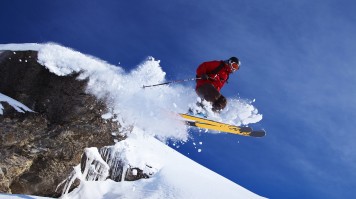 Skier jumping on snowy slope stock in Switzerland