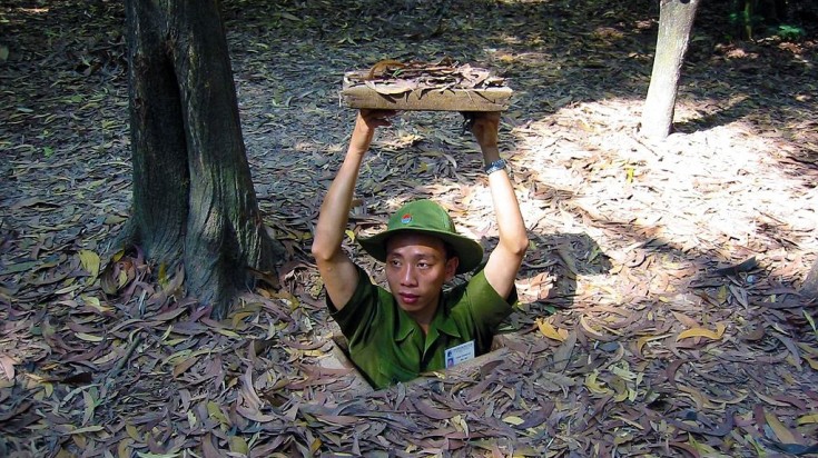 Guide in Ho Chi Minh city coming out of Cu Chi tunnels