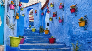 In some ways reminiscent of the White Villages of Andalusia just across the Mediterranean, Chefchaouen is a picturesque town of white and blue buildings that nestles on the side of a hill in the Rif Mountains. the blue alleys of Chefcauouen in Morocco