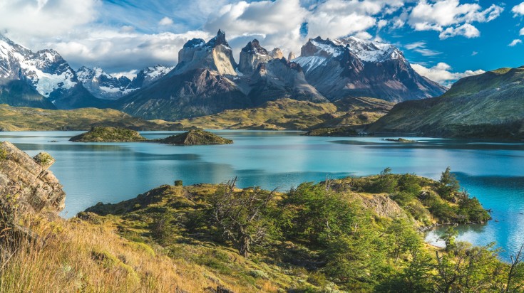 Blue lake on a snowy mountains with cloudy sky, Torres del Paine National