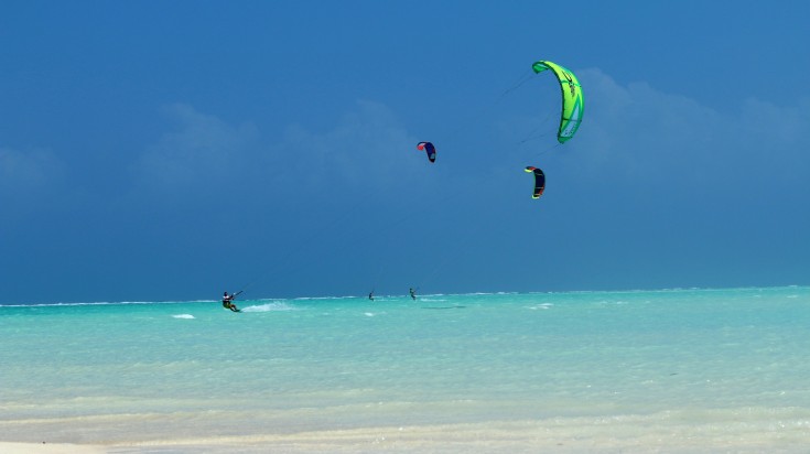 Tourists kitesurfing on the Paje beach.