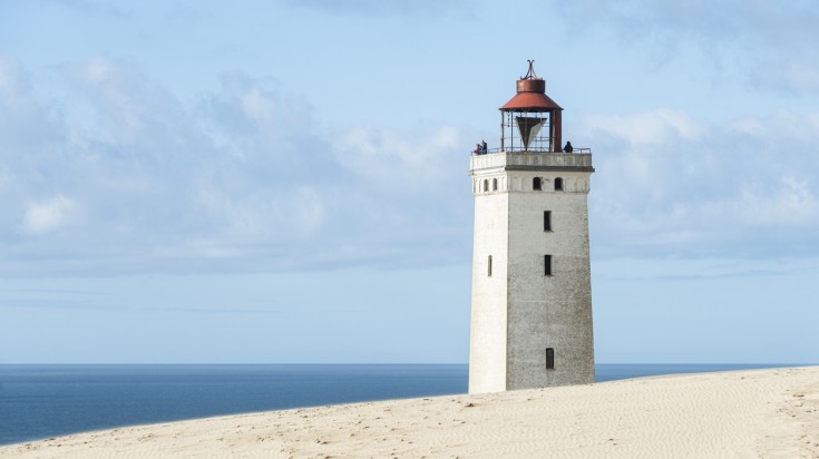 Tourists looking at the blue sea from the Rubjerg Knude Lighthouse. Tourists looking at the blue sea from the Rubjerg Knude Lighthouse.
