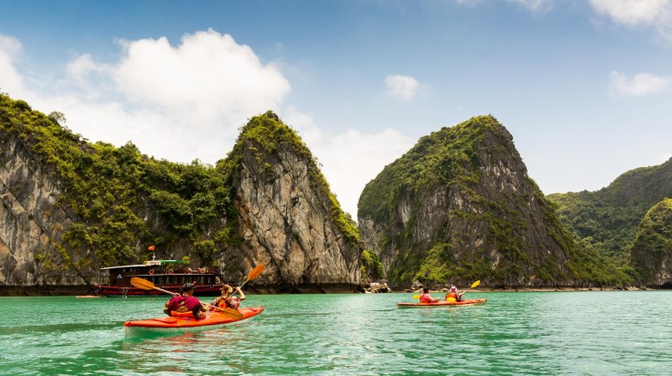 Two kayaks paddling in Halong Bay.