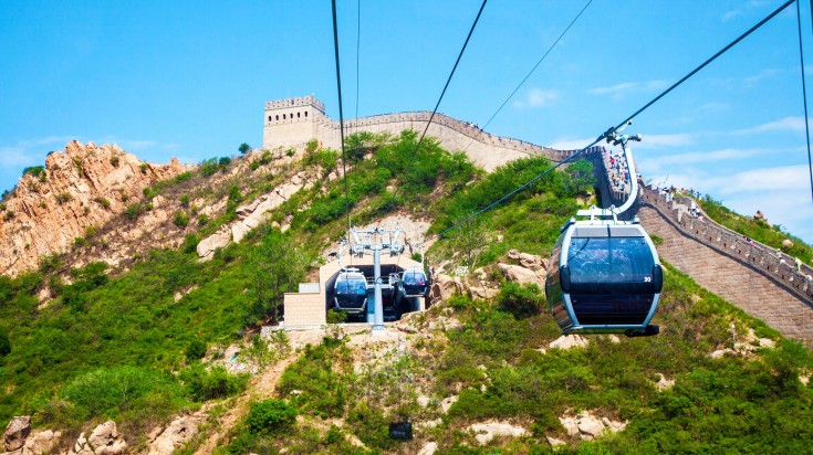 Tourists enjoying a visit to the Great Wall of China in cable cars