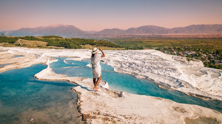 Watch the evening sky from a thermal pool in Pamukkale.