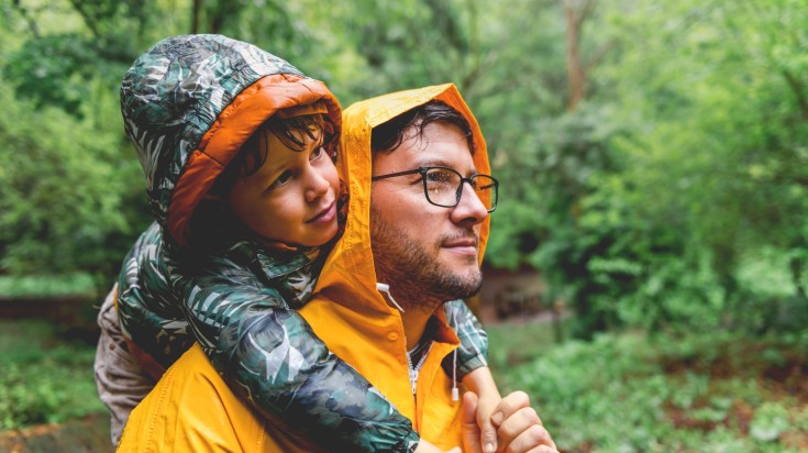 Father and son having fun on a rainy day in Bolivia in November.