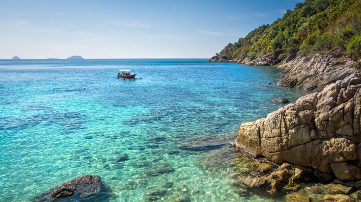 Boat floating on the waters of Perhentian Kecil island in Malaysia in March