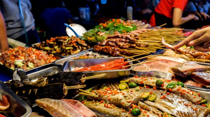 People enjoying street foods in the Philippines in December.