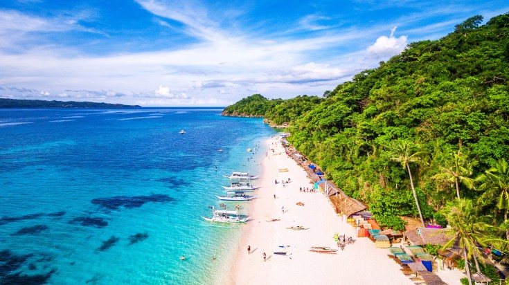 Visitors enjoying their time at the beach in the Philippines in February.