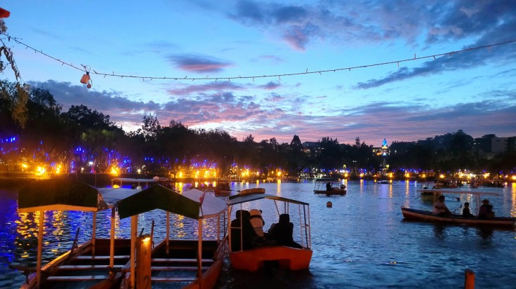 Visitors on boats enjoying the evening at Burnham Park in the Philippines in January.