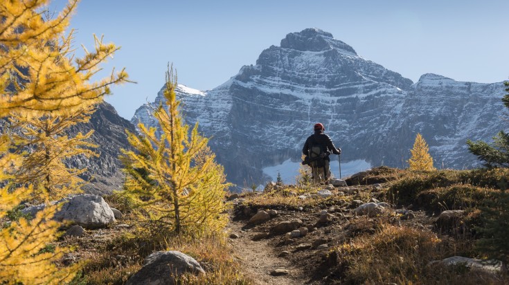 A man hiking in Yoho National Park in Canadian Rockies in September.