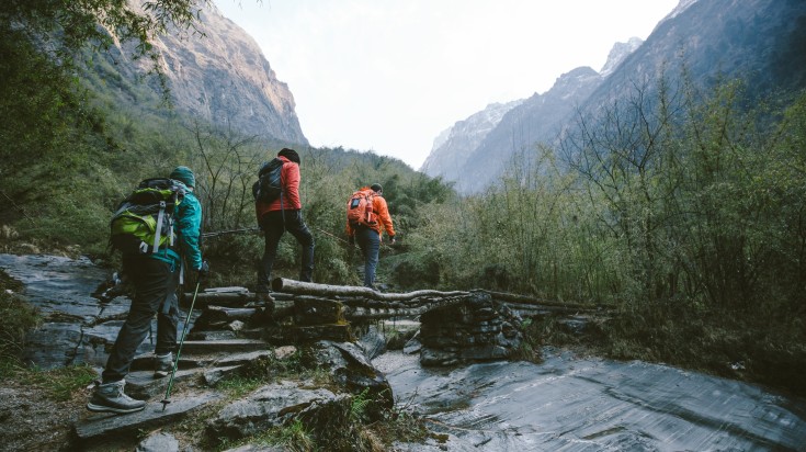 Group of trekkers cross the bridge at Annapurna region in Nepal in August. Group of trekkers cross the bridge at Annapurna region in Nepal in August.