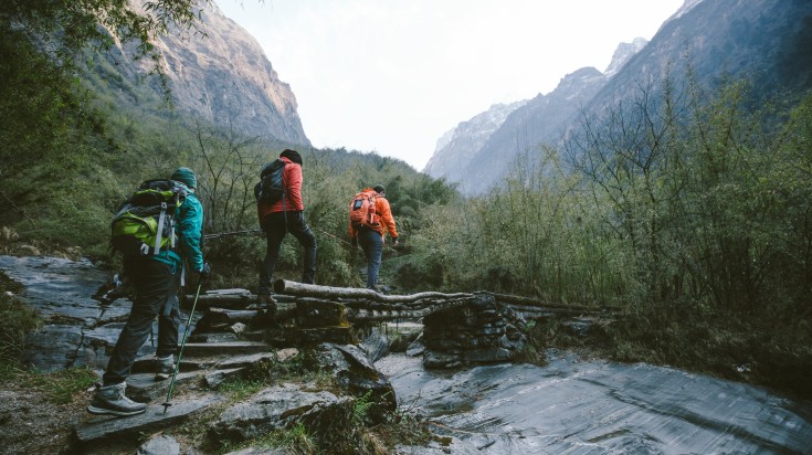 Group of trekkers cross the bridge at Annapurna region in Nepal in August.