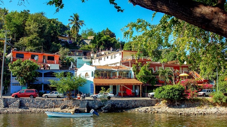 Colorful houses next to a pond in Zihuatanejo in Mexico