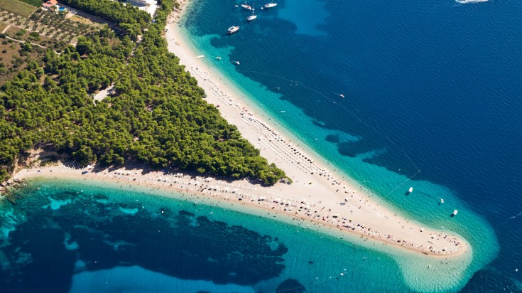 Visit the spectacular Zlatni Rat beach in Croatia in August.