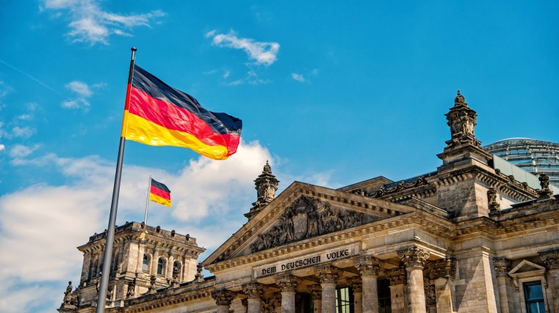 Observe the Germany flag waving at the famous Reichstag building during your 10 days in Germany.