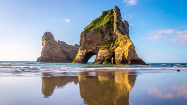 Spend one week in New Zealand and head to Wharariki Beach for relaxation.