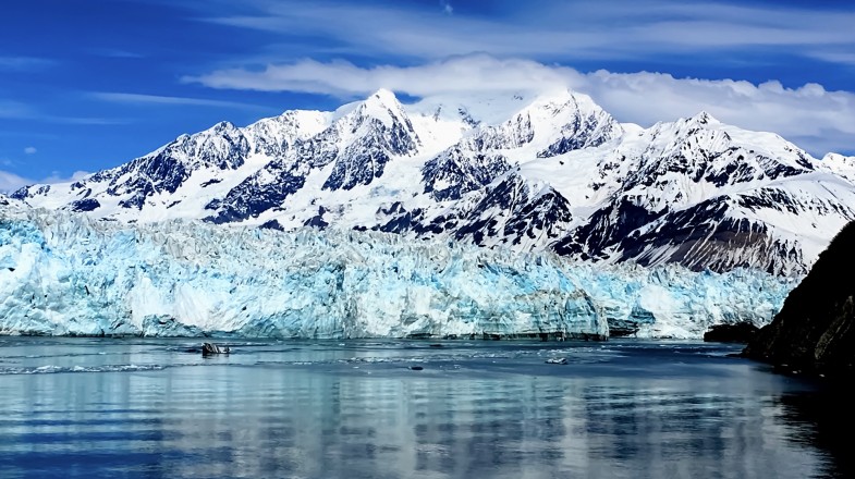 An Alaska cruise ship sailing parallel to glaciers on the frosty ocean