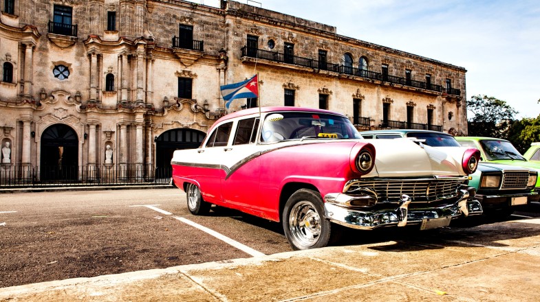 Old vintage cars parked outside in Old Havana in Cuba in February.