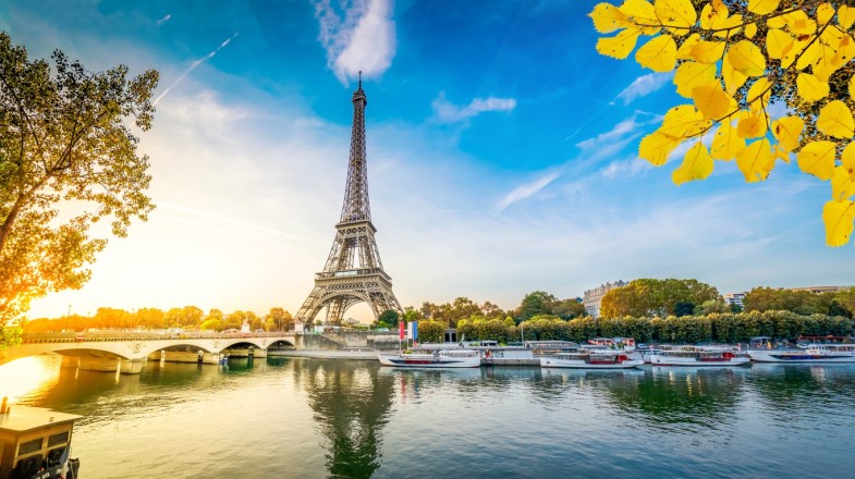 Eiffel tour over Seine river and clear blue sky in France tour.