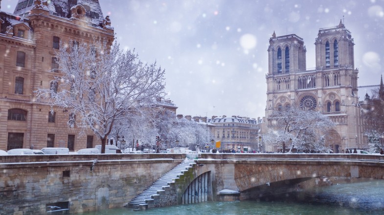 Flooded Seine River covered with snow after snowfall in France in January.