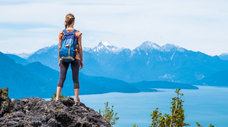 A young hiker stands in the rock and enjoys the view in Patagonia in February.