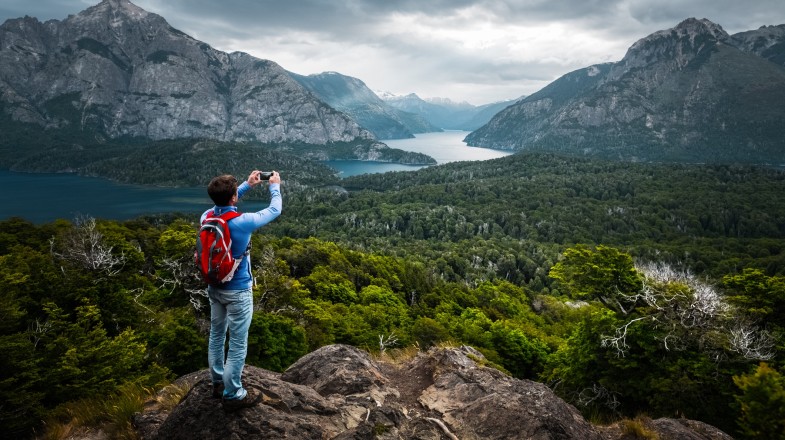 A hiker clicking photo of the landscape during during his 8 days in Argentina trip.