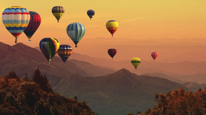 Hot air balloons floating in the clear skies of Kenya in January.