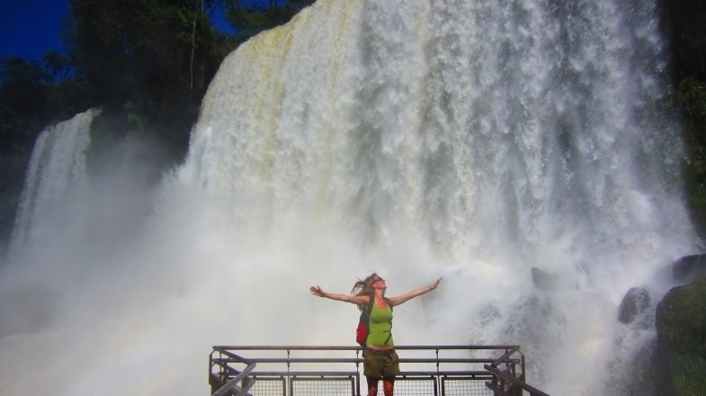 A tourist girl admiring the magnificence of Iguazu Falls during her 3 weeks in Argentina.