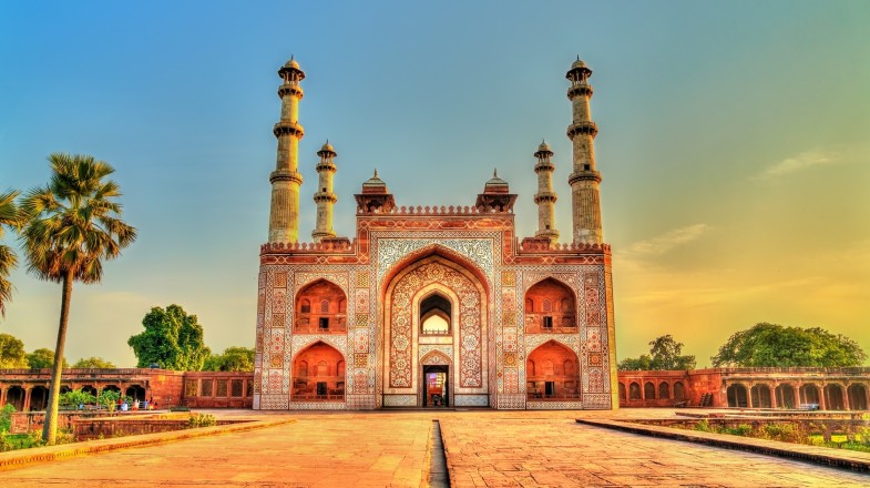 A red structure in India with white patterns on the walls