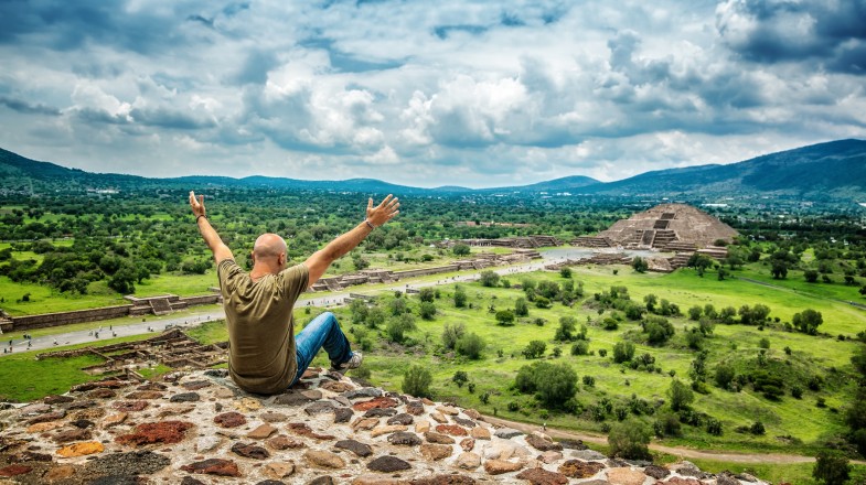 A tourist looks at the pyramids of Sun and Moon in Teotihuacán, one of the top things to do in Mexico