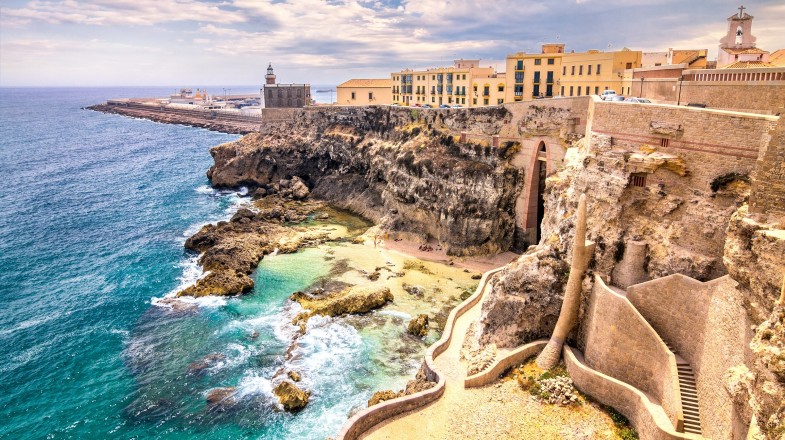 City walls, lighthouse, and harbor in Melilla, Morocco in April
