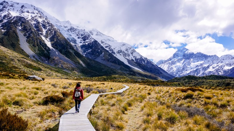 Woman hiking the Hooker Valley trail as she spends 9 days in New Zealand.