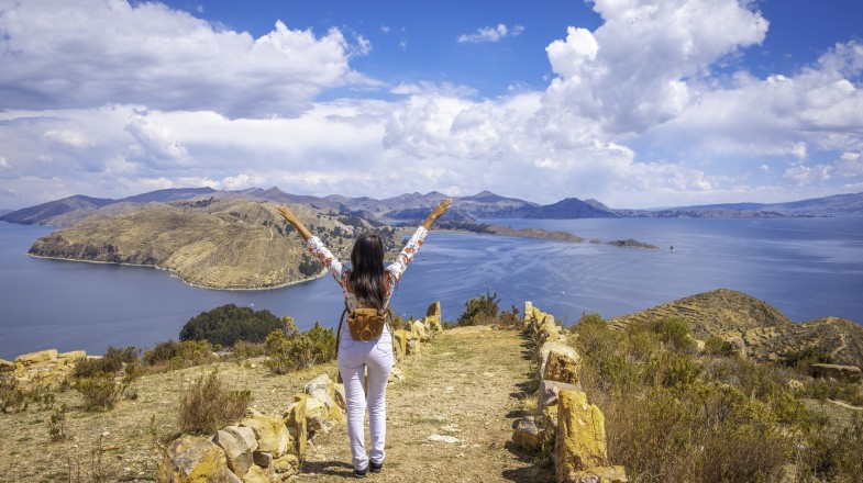 A woman in Lake Titicaca, one of the best places to visit in Peru on a clear day.
