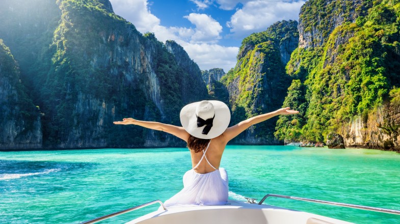 Young woman travelers relaxing and enjoying at Phi Phi Island which is one of the top places to visit in Thailand during summer.