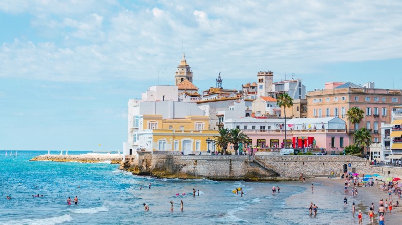 Visitors enjoying beach activities in Summer in Spain in Sitges