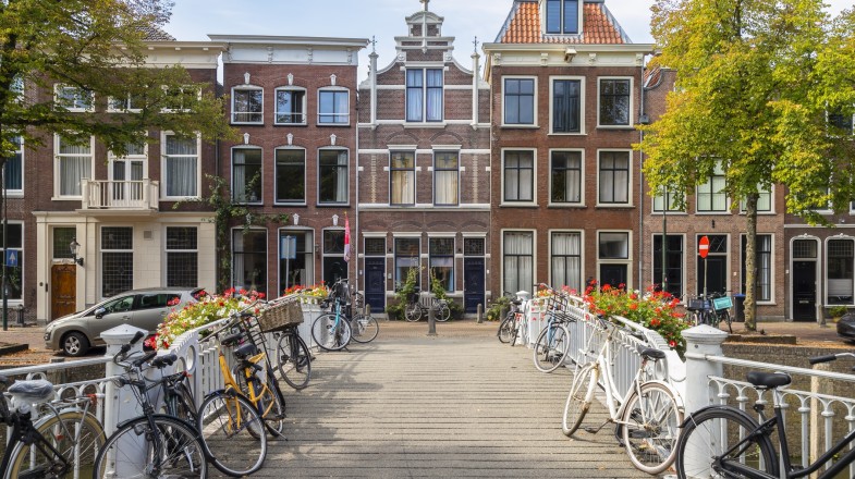 Canal houses with bicycles on a sunny day in the Netherlands in April.