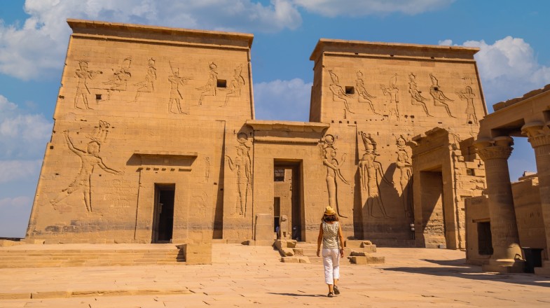 A young tourist exploring the Temple of Philae in Aswan; one of the top things to do in Egypt.