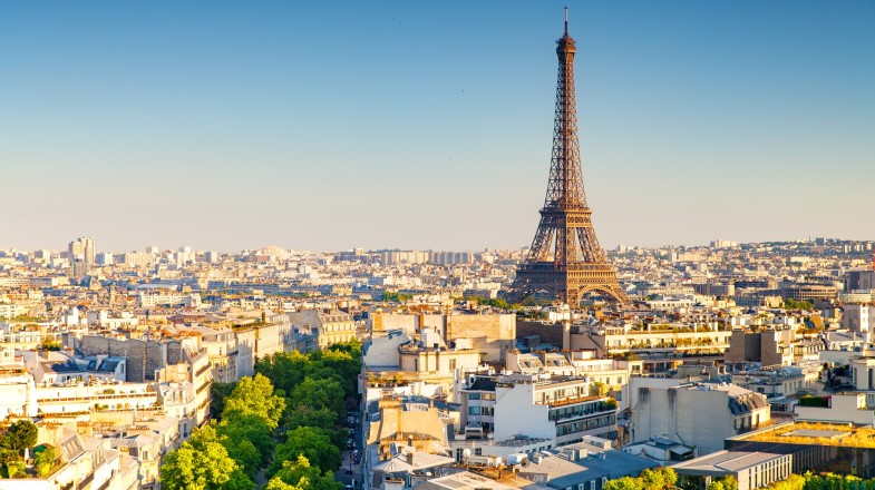 The Eiffel Tower in Paris, France, rises above the city and creates an iconic skyline view.