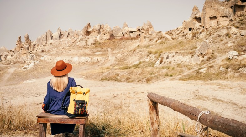 A female hiker sitting on a bench in Cappadocia on Turkey self-guided tour.